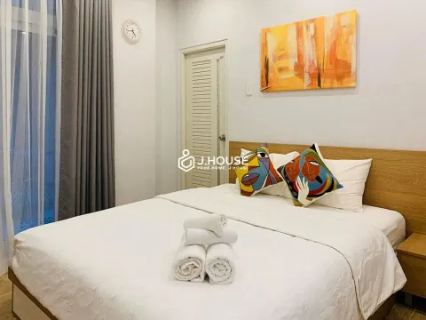 Cozy studio with wooden floor, big windows in central area